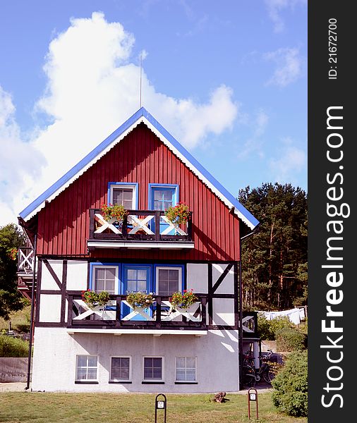 Residential house. Red, blue and white painted walls. Beautiful architectural solution.