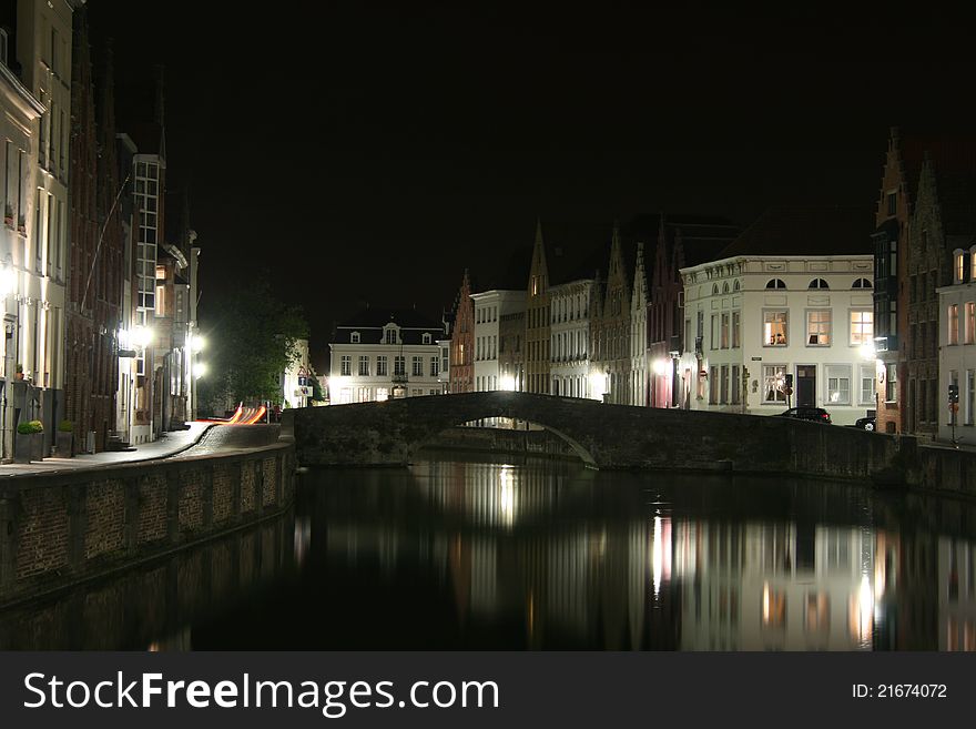 View of some ancient houses and a canal with a bridge in the historical town of Brugge in Belgium. View of some ancient houses and a canal with a bridge in the historical town of Brugge in Belgium.