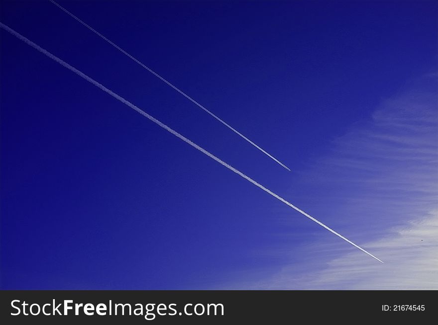 Two jet airplanes racing in the blue sky. Two jet airplanes racing in the blue sky