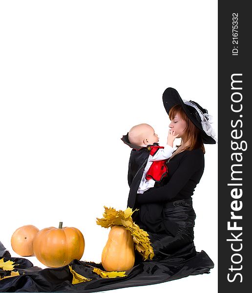 Halloween baby with mother near pumpking