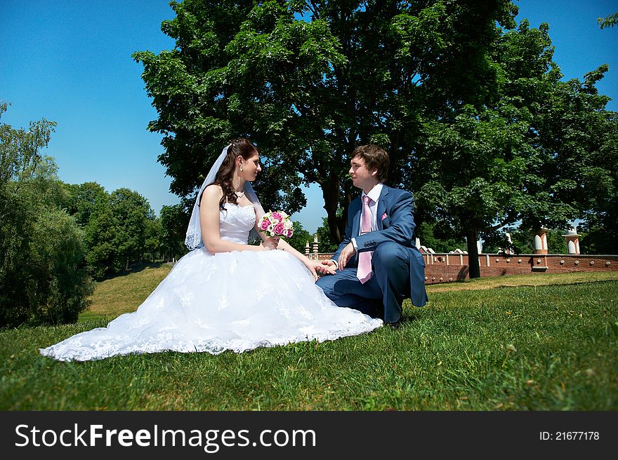 Happy bride and groom at wedding walk in park