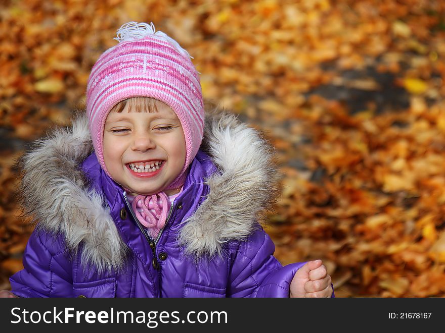 Happiness child smiling in the autumn park. Happiness child smiling in the autumn park