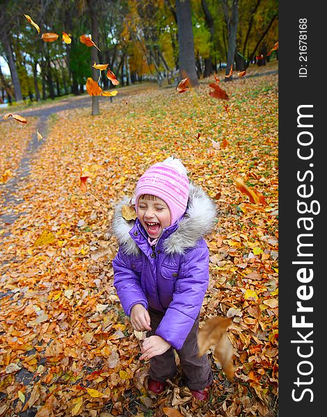 Happiness child smiling in the autumn park. Happiness child smiling in the autumn park