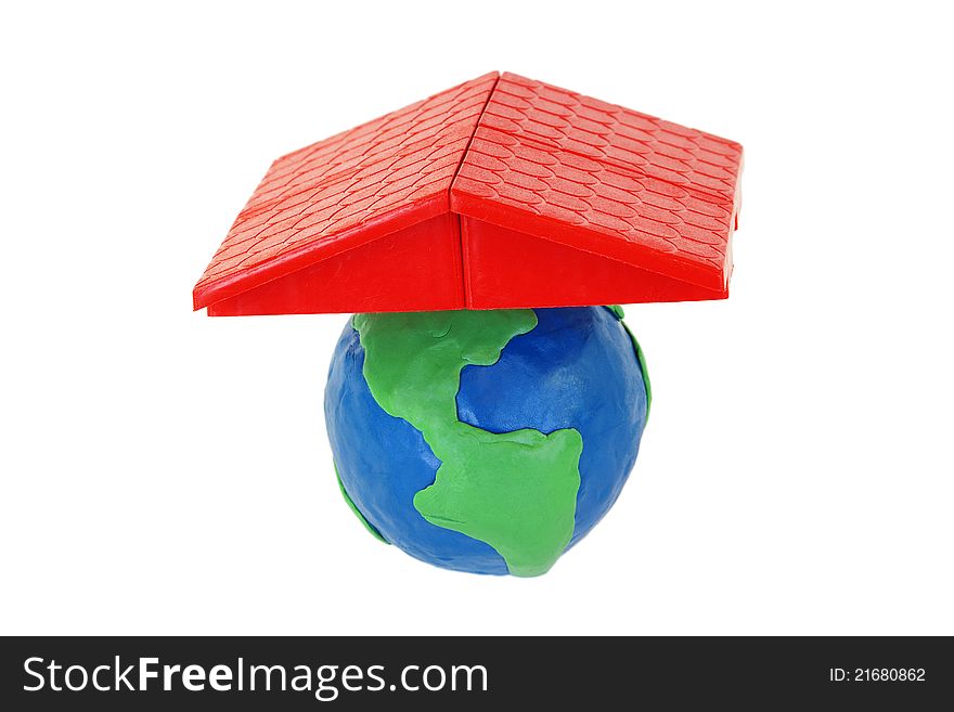The red plastic roof and a plasticine globe on white background. The red plastic roof and a plasticine globe on white background