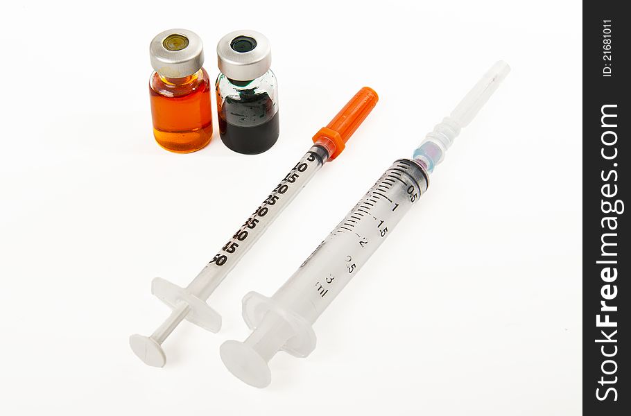 Two Syringes And Two Bottles Of Medicine