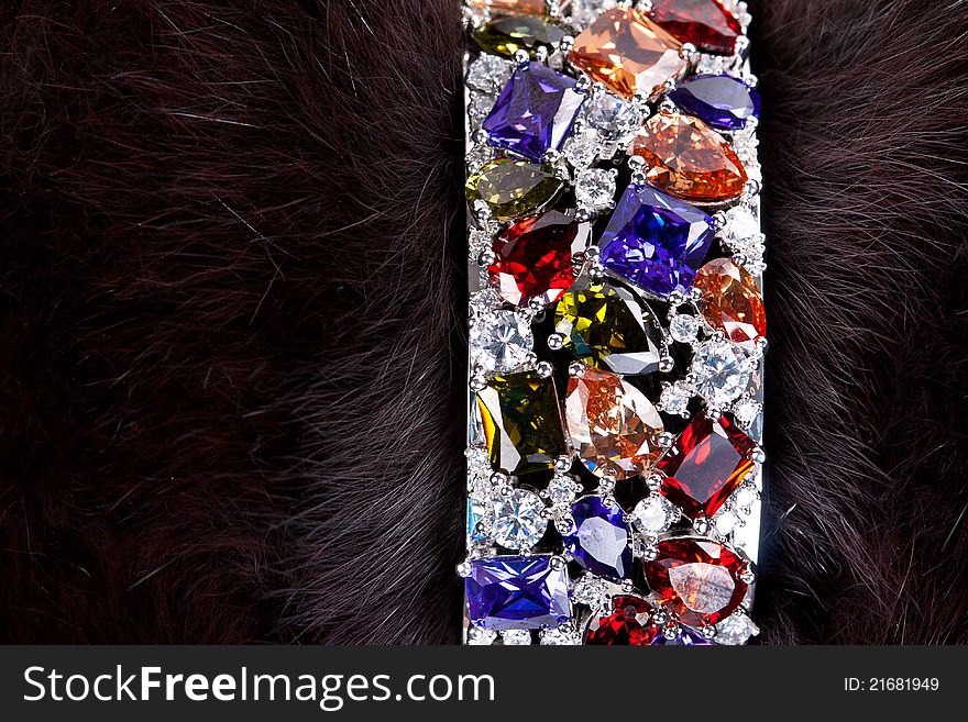 Bracelet with precious stones in a dark fur