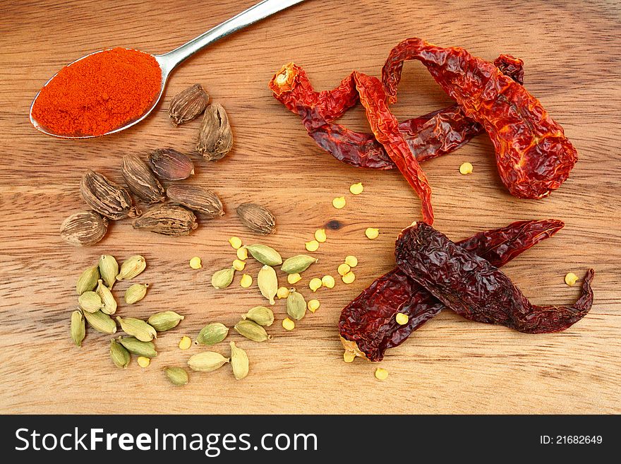 Dried chillies, chilli seeds, whole black and green cardamoms and chilli powder. Dried chillies, chilli seeds, whole black and green cardamoms and chilli powder.