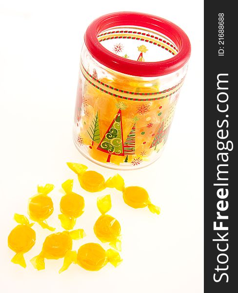 Foil wrapped yellow candies in jar
