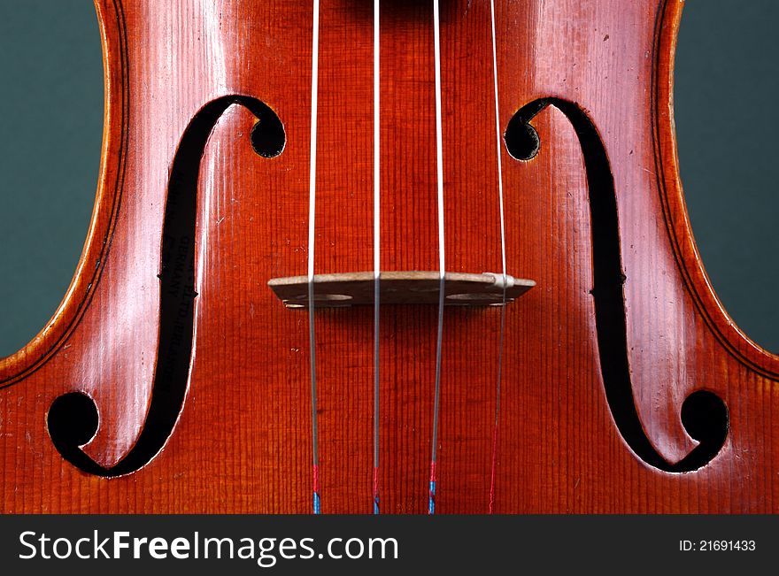 Antique violin close-up showing f-holes, sound-holes, approximately 80 years old