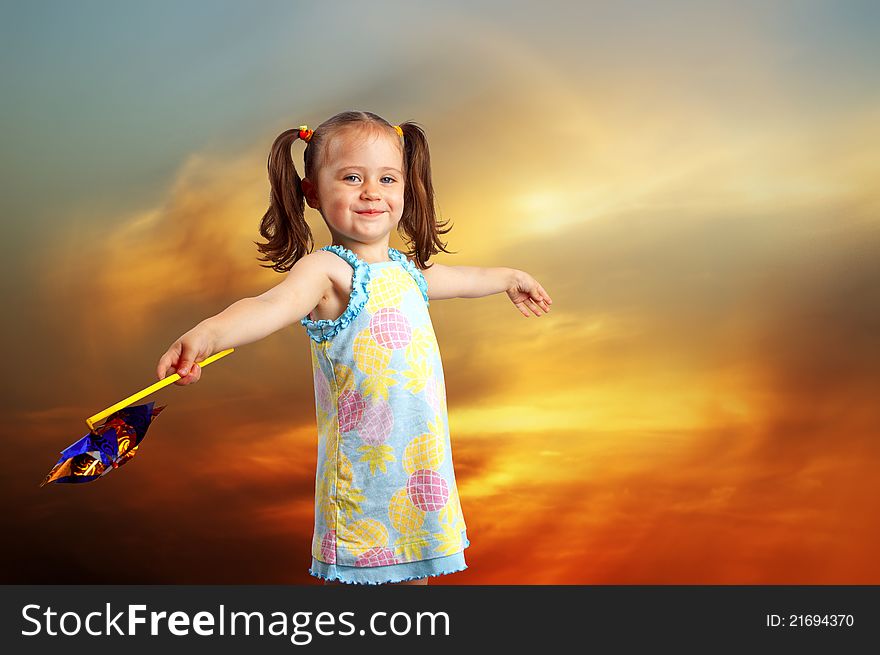 Happy little girl playing with a propeller.Outdoor