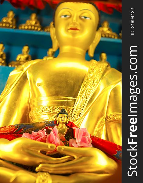 Golden Buddha sculpture in Tibetan Monastery