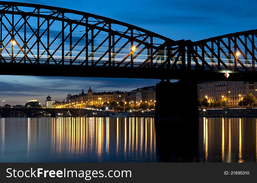 Railroad bridge over the river in the city after sunset. Railroad bridge over the river in the city after sunset