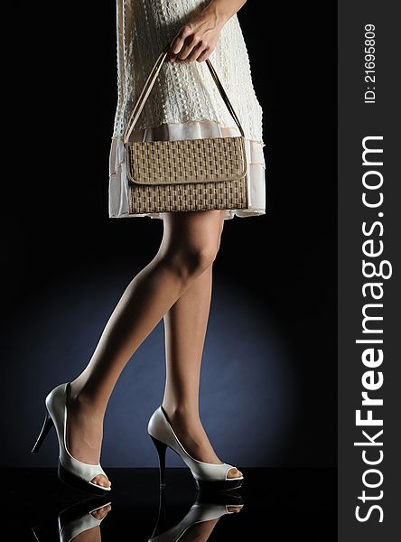 Woman legs with handbag. Woman legs with handbag