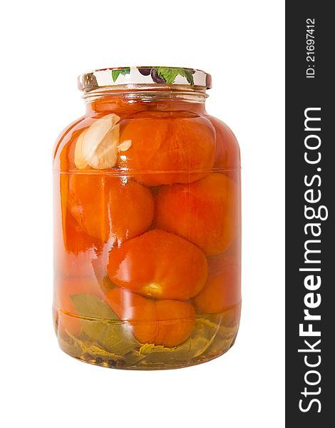 Marinated tomatoes in a glass jar isolated on white background