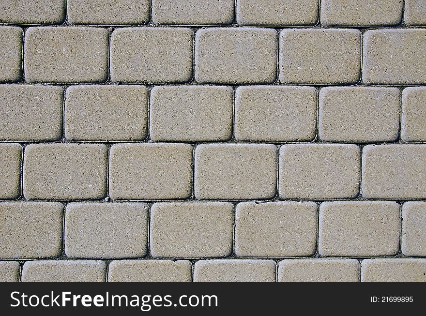 Path background fragment. Path made of small grey bricks.