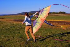 Young Girl Running With Kite Stock Photo