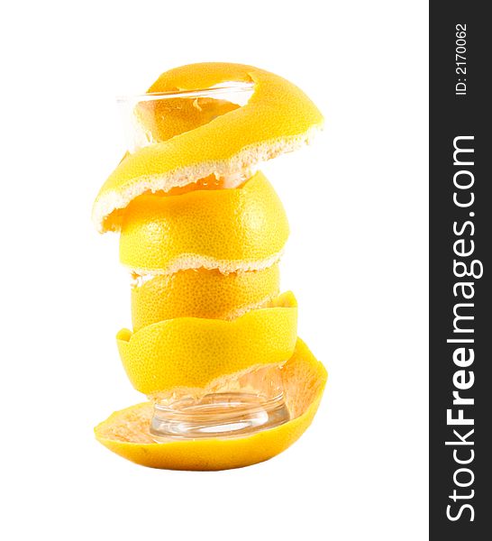 Empty glass with a grapefruit peel selected on a white background