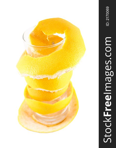 Empty glass with a grapefruit peel selected on a white background