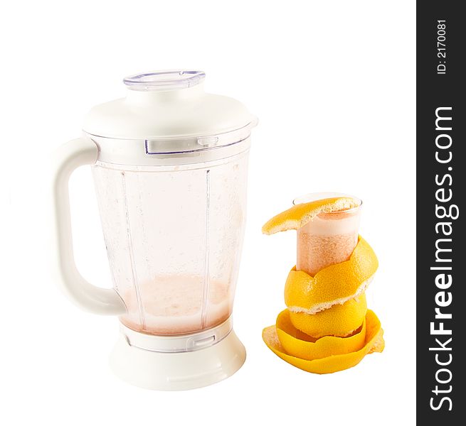 Glass with juice, grapefruit peel and a blender selected on a white background