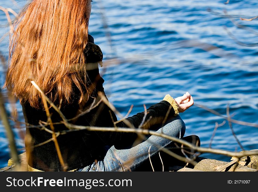 Woman At Yoga Pose At The Lake