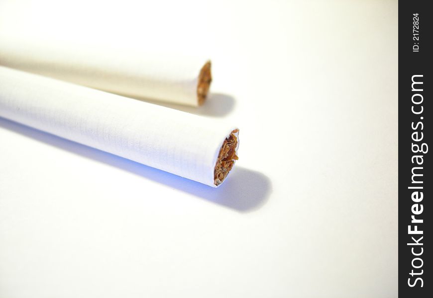 Two cigarettes on a white background. Two cigarettes on a white background