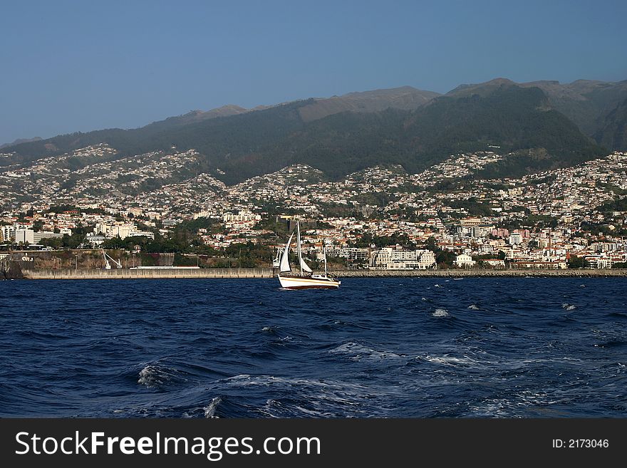 Yacht and Funchal as background, Madeira, Portugal