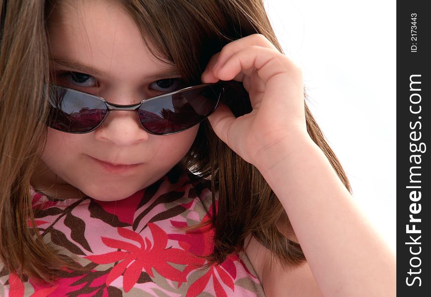 Little girl wearing sunglasses giving big attitude. Little girl wearing sunglasses giving big attitude