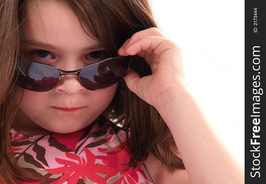 Little girl wearing sunglasses giving big attitude. Little girl wearing sunglasses giving big attitude