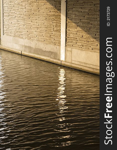 Reflection in a canal under a bridge in the evening Sun. Reflection in a canal under a bridge in the evening Sun