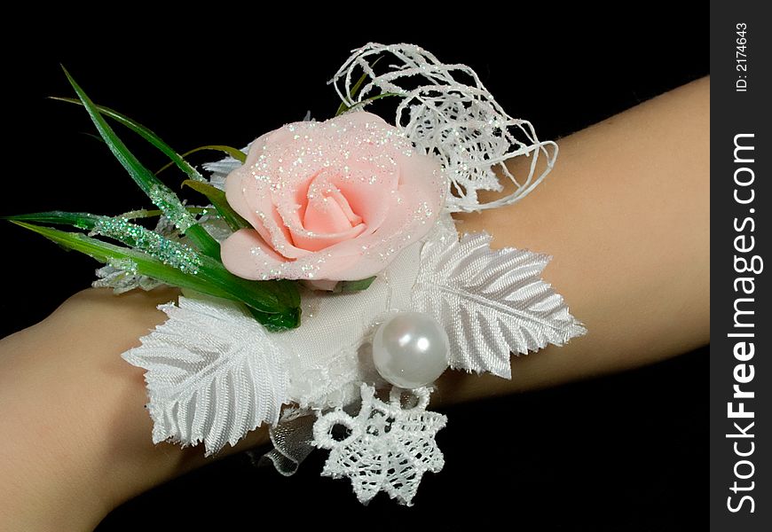 boutonniere on a hand of the bride in color