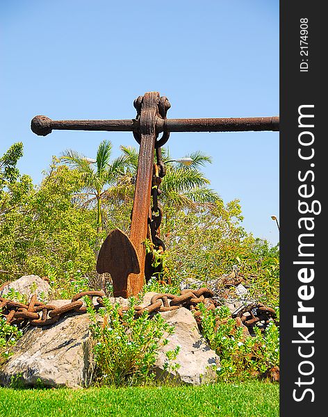 Rusty anchor monument in a sunny tropical location