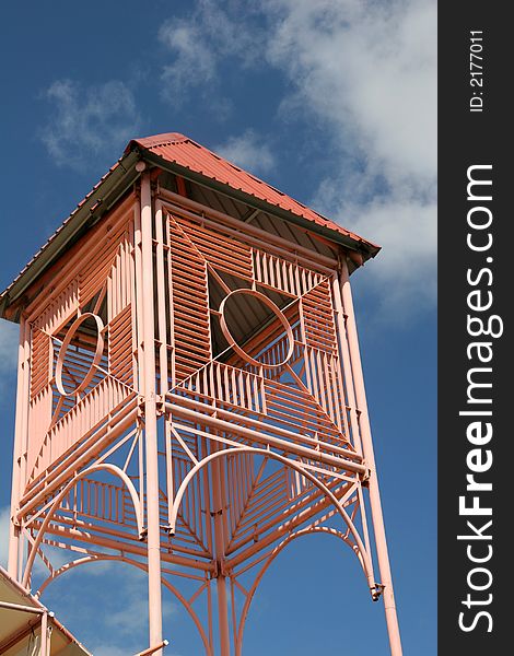 A Bright pink tower against a blue sky