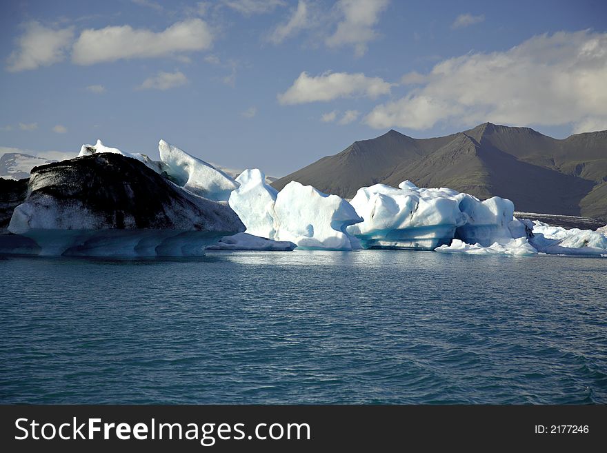 Icebergs on Jokulsarlon lagoon lit by the sun in Iceland. Icebergs on Jokulsarlon lagoon lit by the sun in Iceland