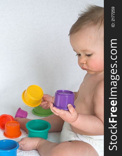 Image of adorable baby playing with stacking cups. Image of adorable baby playing with stacking cups