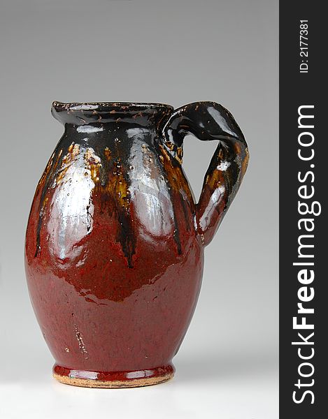 Ceramic jug in Brown tones on neutral background