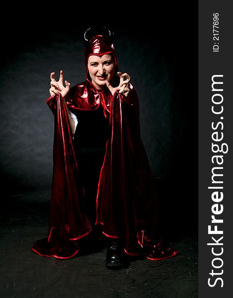 Rage women in red devil costume. Make-up black background. Rage women in red devil costume. Make-up black background.