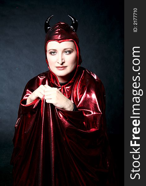 Women in red devil costume. Make-up black background. Women in red devil costume. Make-up black background.