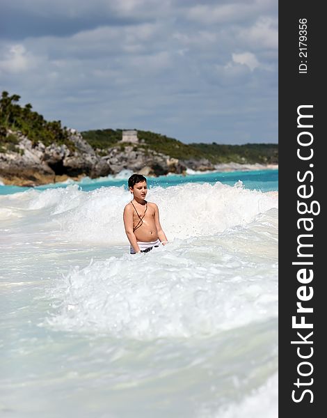 Boy playing in ocean waves