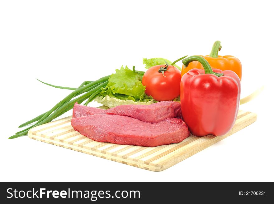 Vegetables and raw beef,  on a white background. Vegetables and raw beef,  on a white background