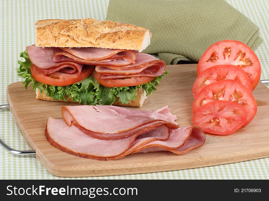Ham and sliced tomato and a sandwich on a tray. Ham and sliced tomato and a sandwich on a tray