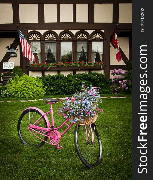 Bike with flowers decorating front yard. Bike with flowers decorating front yard