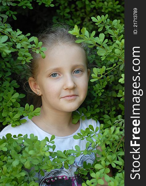 Child girl portrait in the leaves poses