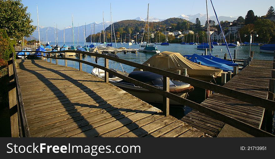 The board walk and marina of the Swiss town of Spiez in Lake Thun, Switzerland. The board walk and marina of the Swiss town of Spiez in Lake Thun, Switzerland.