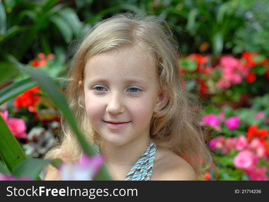 Child girl portrait in the flowers. Child girl portrait in the flowers