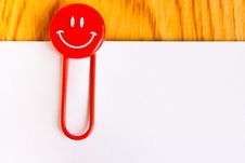 Close Up Of A Red Paper Clip And White Paper Royalty Free Stock Image