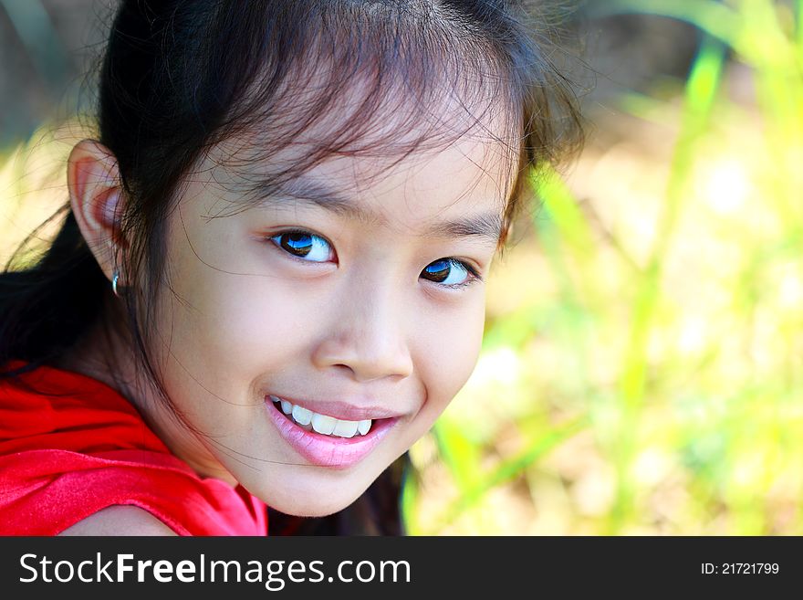 Closeup Portrait Of A Happy Young Girl Smiling