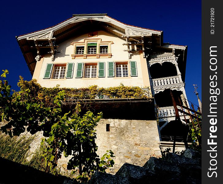 The old pub right next to Spiez Castle in the town of Spiez, Switzerland, on Lake Thun. The lower part of the castle keep dates back to the 10th century. The old pub right next to Spiez Castle in the town of Spiez, Switzerland, on Lake Thun. The lower part of the castle keep dates back to the 10th century.