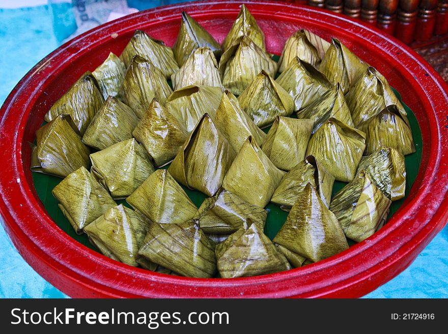 Thai dessert made â€‹â€‹of rice wrapped in banana leaves. Thai dessert made â€‹â€‹of rice wrapped in banana leaves.