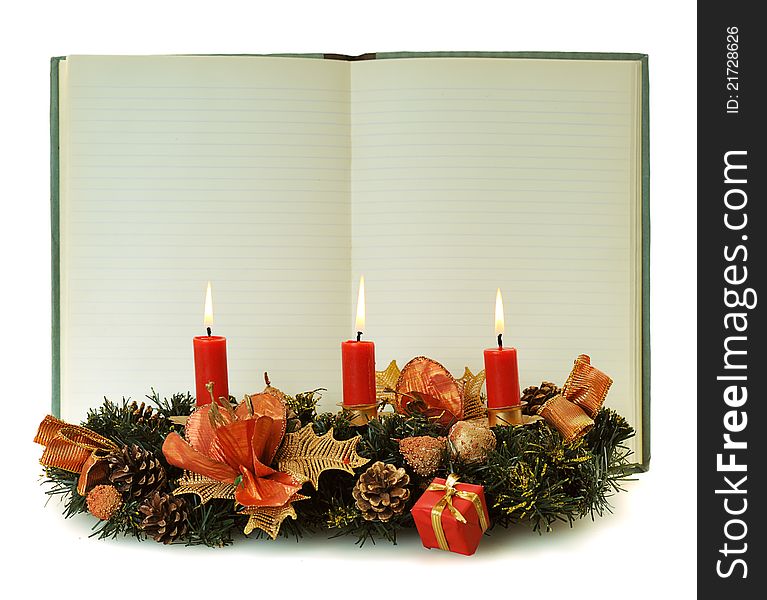 Blank pages of old open notebook bordering with christmas decoration and red burn candle. Blank pages of old open notebook bordering with christmas decoration and red burn candle