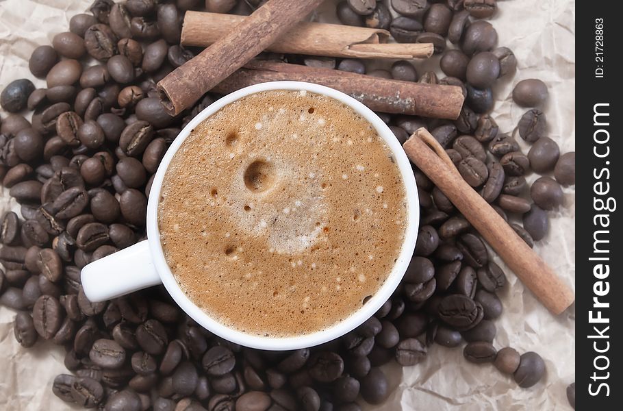 Coffee cup and roasted beans, close up photo